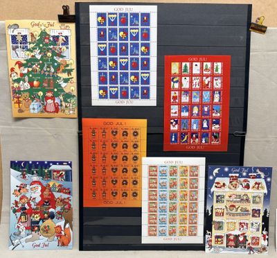 many different christmas cards displayed on a table