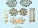 a lot of brooches and hair clips on a blue surface