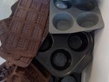 a container with muffins and chocolates inside of it