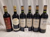 several bottles of wine are lined up on a table