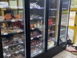 a man sitting on the floor in front of a freezer