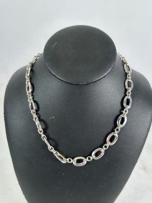 a close up of a necklace on a mannequin display