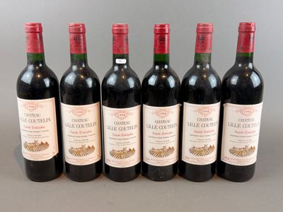 six bottles of wine are lined up in a row on a table