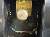 a clock that is sitting in the corner of a cabinet