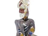 figurine of a woman sitting on an elephant with a basket on her head