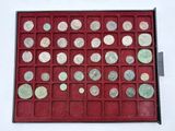 an assortment of silver and bronze coins in a red display case