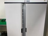 two refrigerators that are sitting in a kitchen