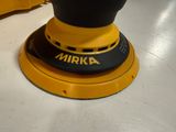 yellow and black orbital sander sitting on top of a white floor