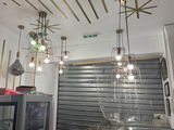 many lights hanging from the ceiling in this restaurant
