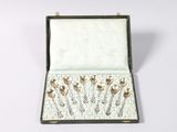 a box that has a bunch of silver spoons in it