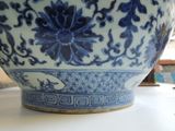 a large blue and white bowl sitting on a table