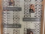 many pairs of glasses on display in a display case