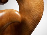 an image of a wooden sculpture of a bird on a stand