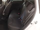 the back seats of a white car with a black seat belt