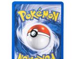 a close up of a pokemon card on a white surface