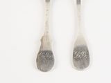 two spoons that are sitting next to each other