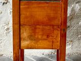 a small wooden table with a drawer on top of it