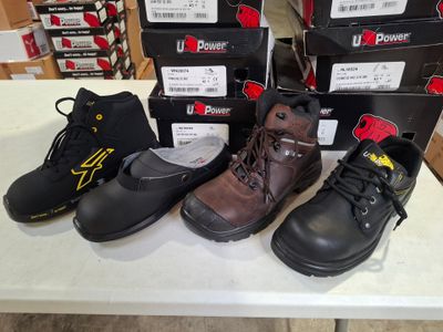 several pairs of work boots are lined up on a table