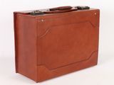 a brown suitcase sitting on a white surface