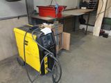 a yellow and black welding machine in a garage