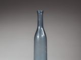 a blue glass bottle that is sitting on a table