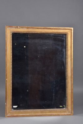 an antique gold framed mirror with a black background and gold trim