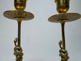 two gold candles that are sitting on a table
