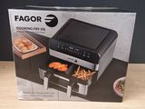 the box of the air fryer is open on the table