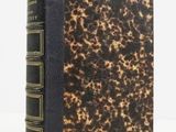 a close up of a book on a white surface with a white background