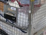 a large metal cage with a lot of items inside of it