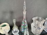 many glass vases sitting on a shelf next to each other