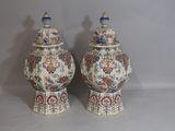 two vases that are sitting on a table