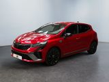 Une Toyota C-HR rouge est garée dans une pièce blanche