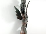 bronze statue of a woman holding a flower in her right hand