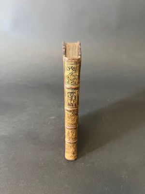 an old book with writing on it sitting on a table