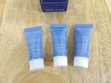 two tubes of skin care sitting on top of a wooden table