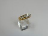 a close up of a gold ring with three diamonds on it