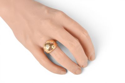 an image of a woman ' s hand with a gold ring on it