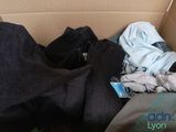 a cardboard box filled with clothes and a laptop