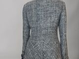 a close up of a mannequin jacket on a mannequin stand
