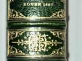 a close up of a roll of green and gold colored thread