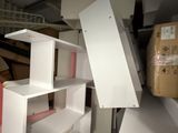 a man that is standing in a room with some shelves