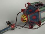 a small toy train that is attached to a pole