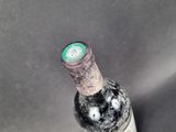 a bottle of wine that has been left on the table