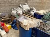 a pile of junk in a room next to a brick wall