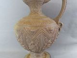 a vase that is sitting on a table with a white background
