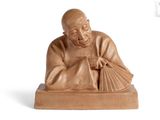 an image of a statue of a man holding a fan