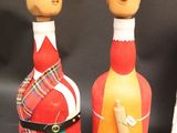 three wine bottles that have been decorated with a man ' s face on them