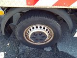 a flat tire on a flatbed truck with a red and white stripe