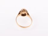 a close up of a gold ring on a white surface